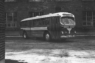 Image shows a bus parked b y the building.