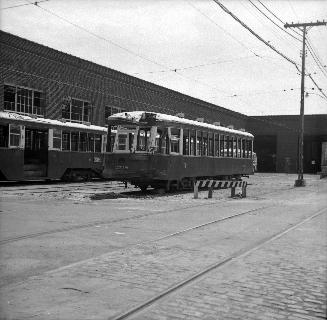 Image shows a rail car by the building.