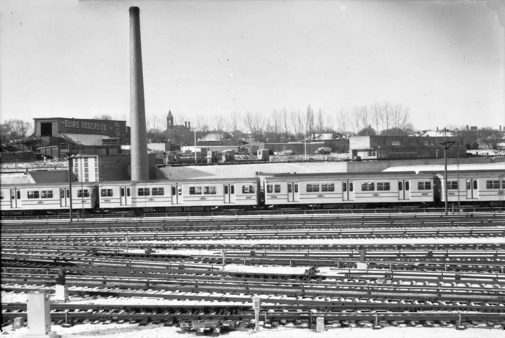 Yonge St. Subway, Davisville Yards, looking west. Image shows multiple tracks and a subway trai…