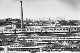 Yonge St. Subway, Davisville Yards, looking west. Image shows multiple tracks and a subway trai…