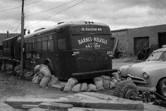 Gray Coach Lines, bus #801, in use as office of Barnes-Melville Limited, Raleigh Avenue, southeast side, east of Birchmount Avenue