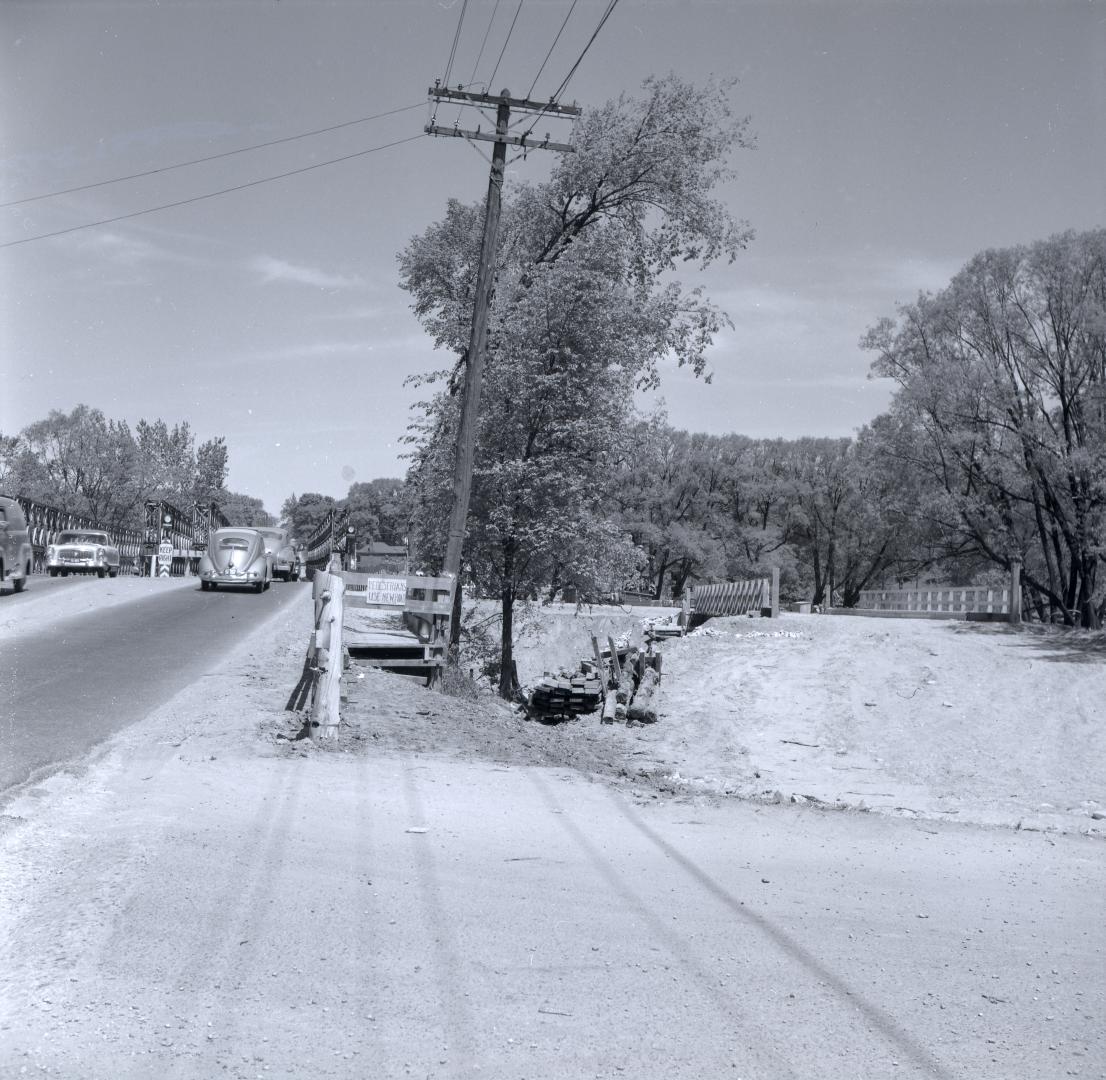 Yonge Street looking north across temporary bailey bridge over West Don River, south of York Mills Rd, showing temporary bridge to east of Yonge Street at right