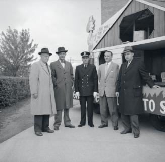 Image shows five gentlemen posing for a photo.