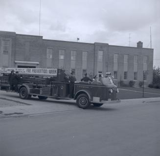 Image shows a fire truck parked by the building.