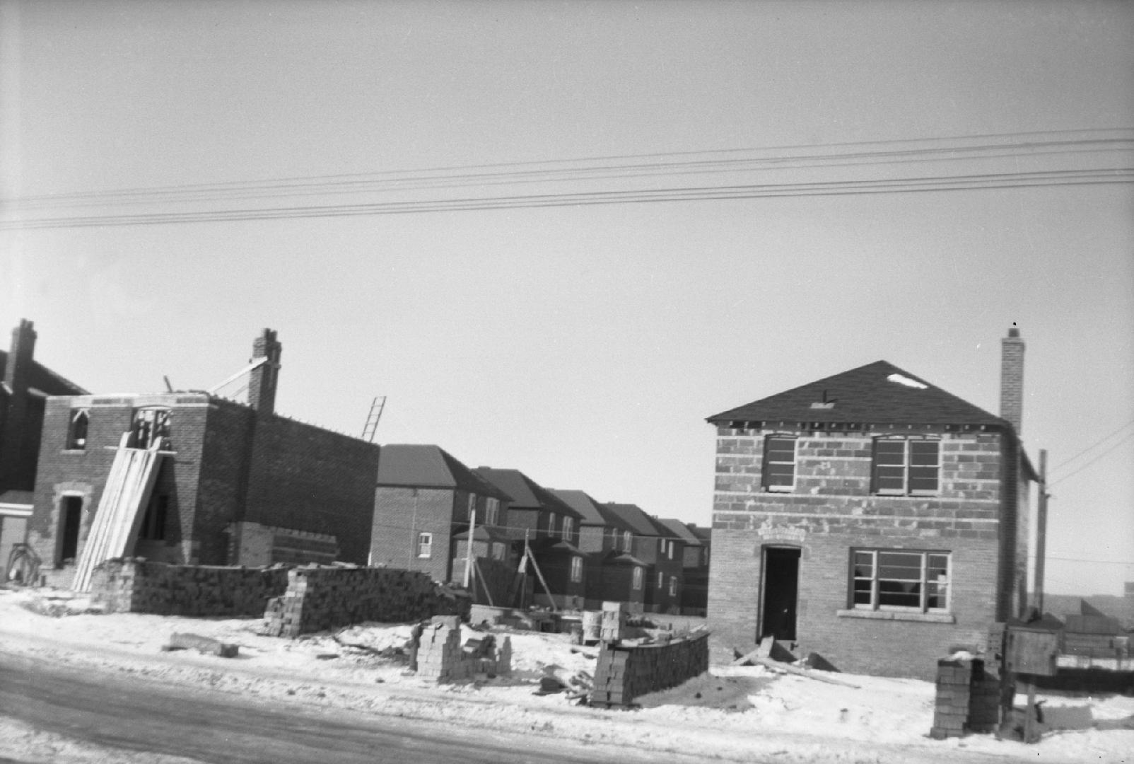 Image shows houses under construction.