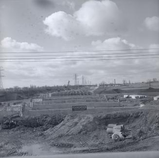 (The) Queensway, looking west from east of Humber River, showing construction of bridge over Humber River
