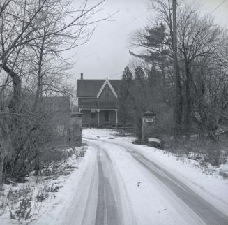 Image shows a road view leading towards the house. 