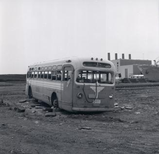 GRAY COACH LINES, bus #1009, on vacant lot at east end of Basin St