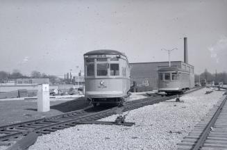 Image shows a few subway cars on tracks outdoors at Davisville yards, Toronto, Ontario.