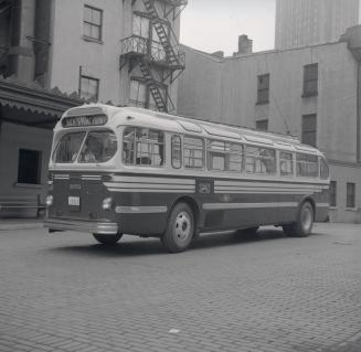 T.T.C., bus #1951, at T.T.C. head office, Yonge Street, northeast corner Front Street East, looking northwest at east side of building
