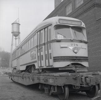 Image shows a rail car loaded on the work car.