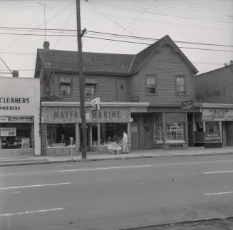 Historic photo of Bedford Park Hotel - Mayfair Marine, Hing Bros Laundry, and M Bloom Custom Tailors from August 25th, 1957