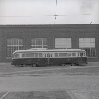 Image shows a rail car beside the building. 