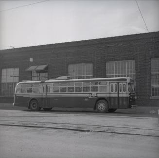  Image shows a trolley bus by the building.
