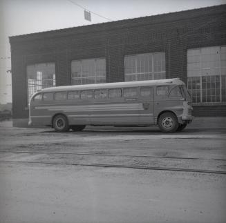 Image shows a bus parked by the building.