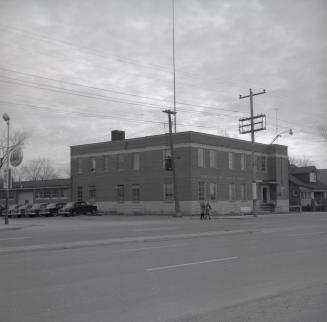 Historic photo from Saturday, December 21, 1957 - Township of North York Police Station across the street from a Lion gas station sign in North York