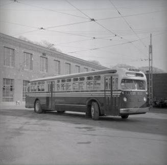 Image shows a bus by the building.
