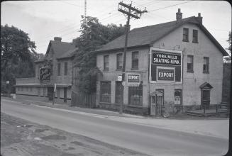 Historic photo from 1954 - Jolly Miller, Hogg Brothers shop, and York Mills Skating Rink sign in Hoggs Hollow