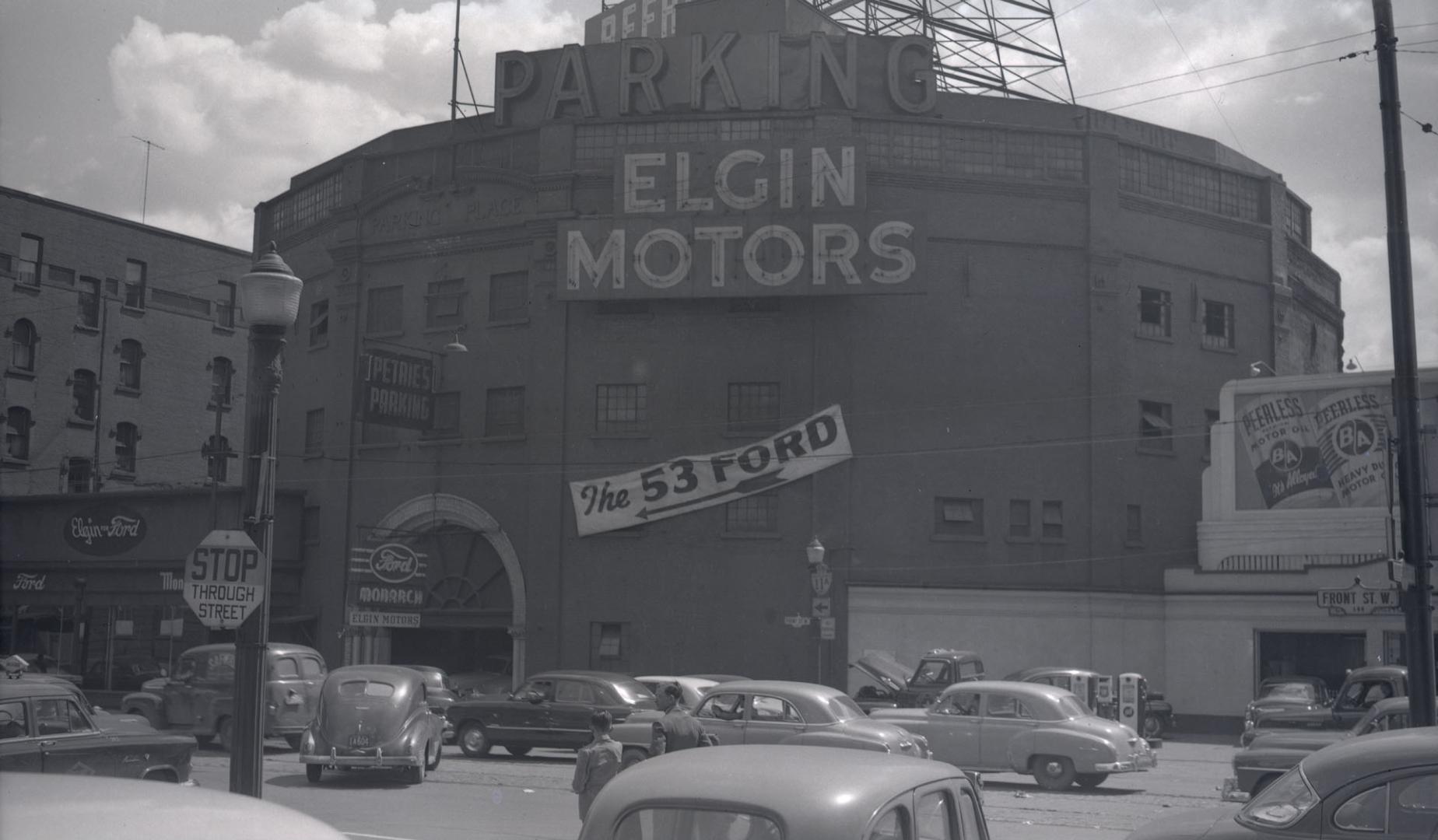 Image shows a building with the sign that reads "Elgin Motors". In front of the building, there ...