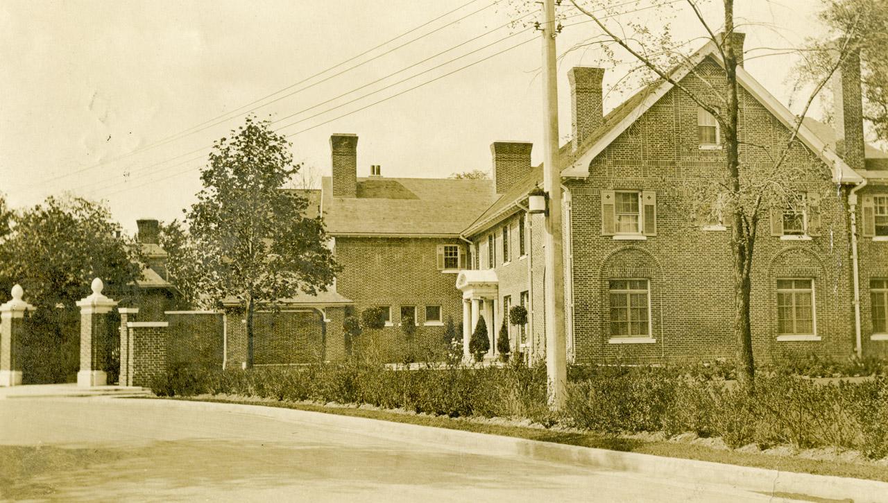 Image shows a two storey house along the street.