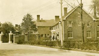 Image shows a two storey house along the street.