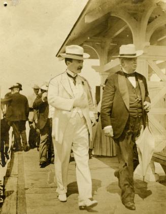 Historic photo from Thursday, August 23, 1906 - F.B. Featherstonhaugh (in white suit) greeting Sir William Broadbent, physician to His Majesty King Edward at the RCYC in Toronto Island