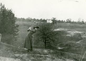 Historic photo from 1900 - Woman playing at the Swansea Golf Links,Morningside Ave., between Durie St. & Lavinia Ave houses in background on Beresford Ave., n. of Deforest Rd. in Swansea