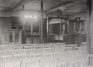 Image shows the interior of a church with lots of chairs in rows.