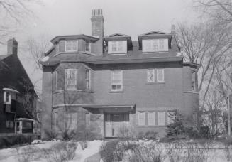 Image shows the front view of a three storey residential house.