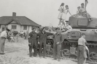 Historic photo from 1940 - Military demonstration in Eglinton Park - kids climbing on tank in North Toronto