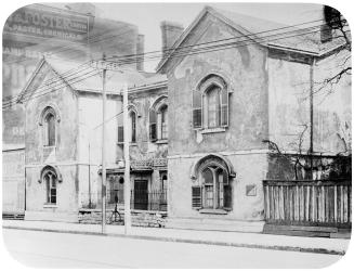 Historic photo from 1924 - Berkeley House for sale and in disrepair next to advertising in Corktown