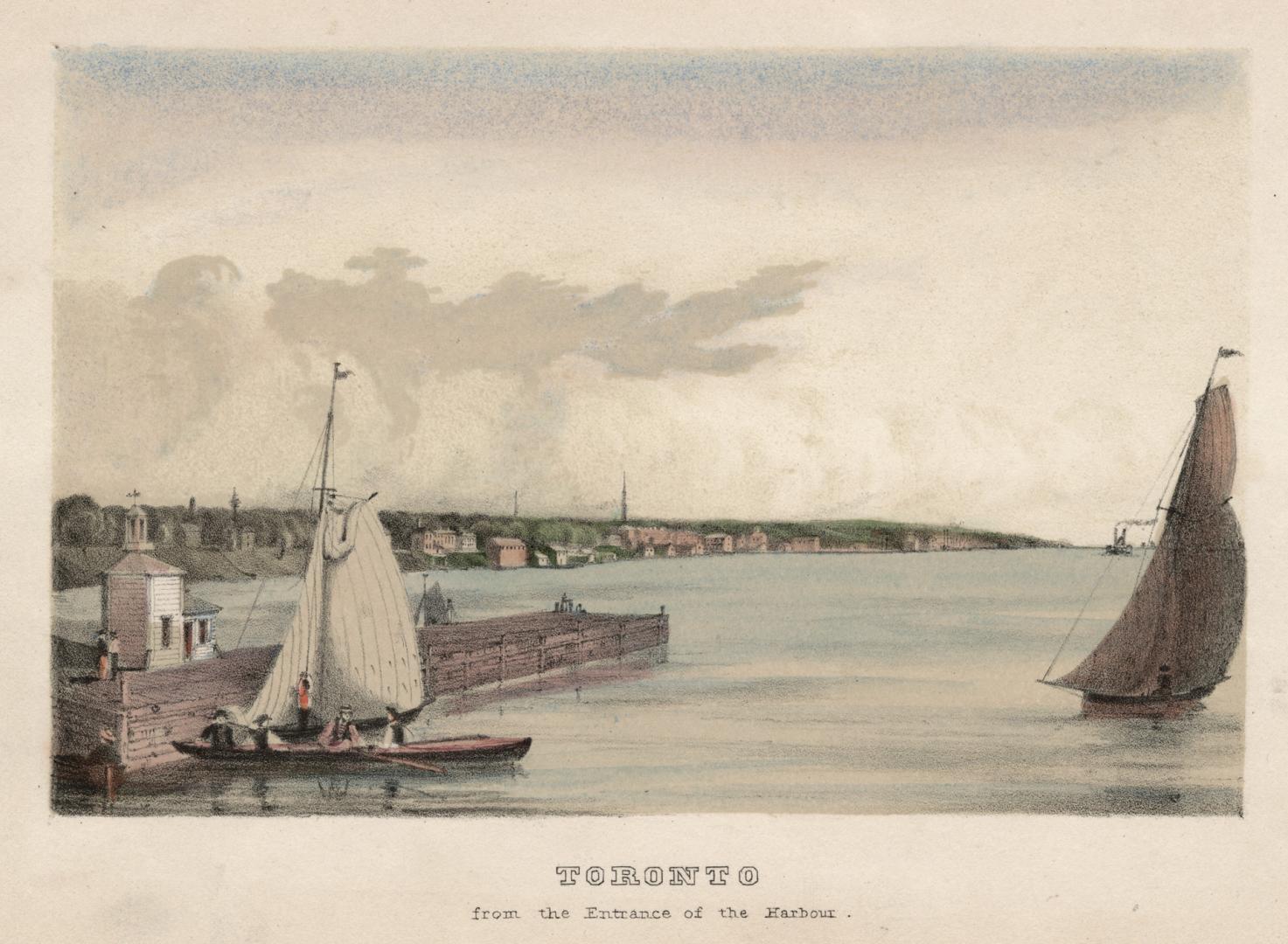 Image shows a lake view with a few sail boats on it and some houses in the background.