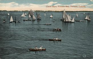 Image shows a number of sailboats and canoes on the lake.