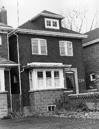 134 Lawrence. Image shows a two storey residential house with an attic and a small porch.