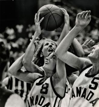 If you can't get the ball - grab an arm - some action in traffic jam under net as Canada's women basketball defeated Brazil. #8 Carol Turney, #5 Dori McPhail