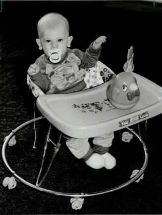 Are walkers unsafe? David McKay, 5 months, looks content in his baby walker, but some doctors say they can be dangerous