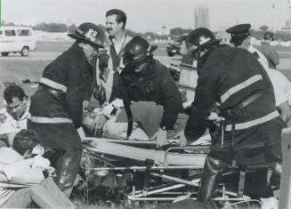 Just testing. Fire and ambulance crews attend to victims yesterday after a mock plane crash at the Toronto Island Airport. In the simulated disaster, (...)