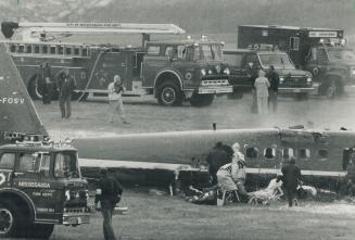 Emergency crews tend to 'victims' of a mock plane crash at Pearson International Airport yesterday