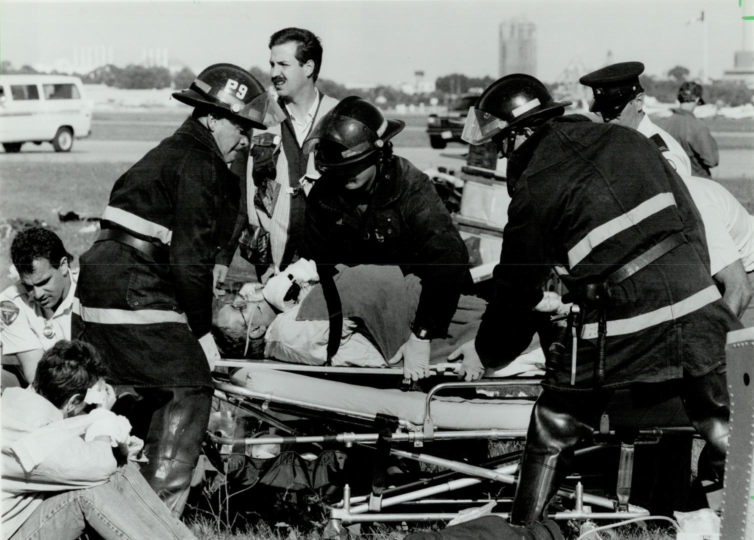 Just testing. Fire and ambulance crews attend to victims yesterday after a mock plane crash at the Toronto Island Airport. In the simulated disaster, (...)