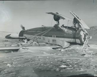 Overturned Norseman lies on ice of tiny lake in wilderness of ungava