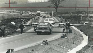 Grounded. A Cessna 411 from which 7 walked away unhurt following an emergency landing early yesterday is towed back to Buttonville Airport. The plane,(...)