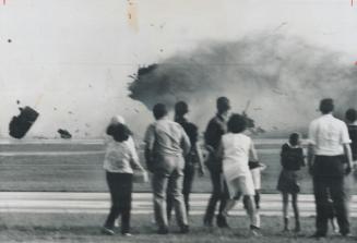 The moment of impact as the plane hits and parts fly