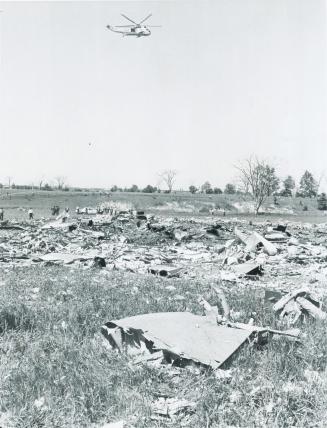 Hovering over death scene of 108 victims of crash of Air Canada s DC-8 jetliner last Sunday, Canadian Armed Forces helicopter moves in to start airlif(...)