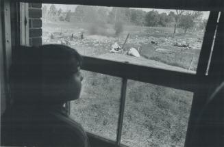 View of wreckage through one of the 10 windows of the Burgsma home blown out by the crash of the jetliner