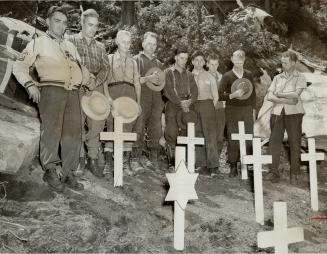 Difficult climb was made by relatives of the dead airmen, seen beside the tiny cemetery