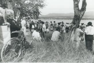 an unidentified handicapped woman watched from her wheelchair as efforts were made to recover the bodies of the hadicapped and mentally retarded men and women who drowned in the accident