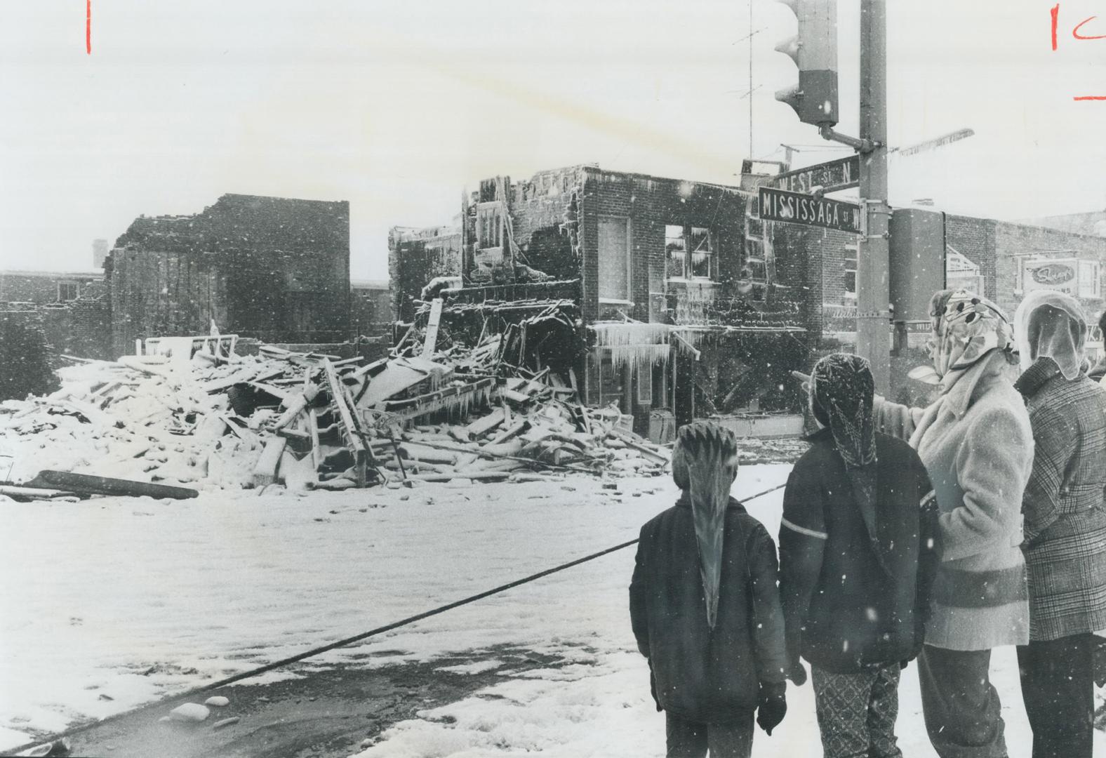 Ice-sheathed ruins are all that remain of four stores and 10 offices above them, destroyed Saturday in a $700,000 blaze that swept part of central bus(...)