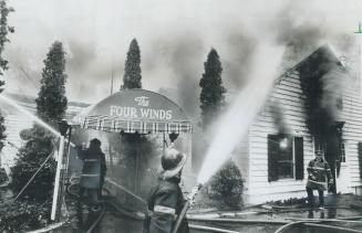 Firemen pour water on the Tri-Bell Four Winds Club on Steeles Ave