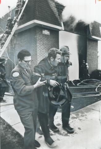 Overcome by smoke inhalation while fighting a fire in a North York townhouse that forced six persons to flee their home, fireman Frank Hall is assiste(...)