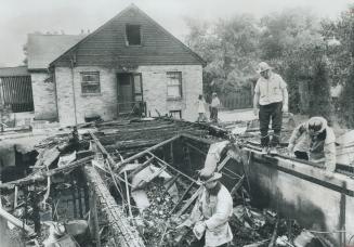 London, Ont., Firemen hose down debris that is all that remains of the Forster house, destroyed by a natural-gas explosion. Nine-year-old Armin Forste(...)